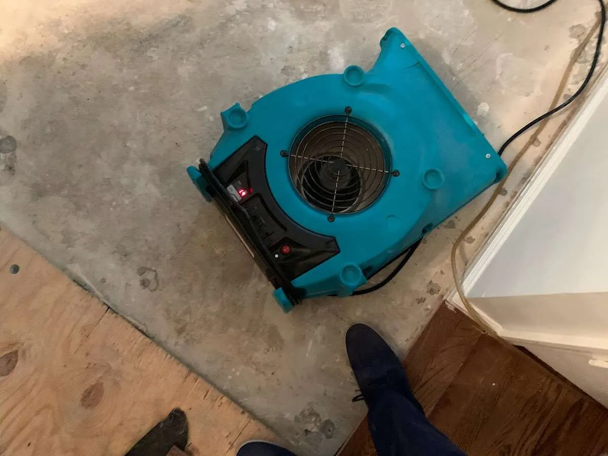 Air mover drying subfloor during Leak Detection & Repair in Decatur